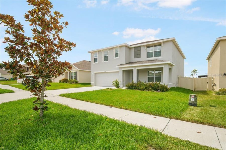 Front exterior of a new home in Abbott Park, Zephyrhills, FL, highlighting curb appeal (Image 19).