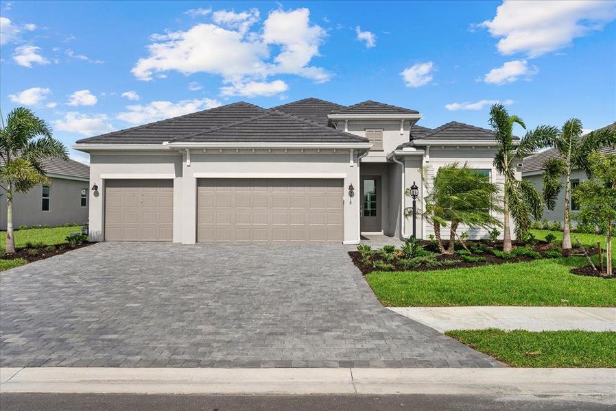 Front exterior of a new home in Calusa Country Club, Lakewood Ranch, FL, highlighting curb appeal (Image 2).