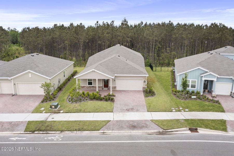 Front exterior of a new home in Tributary, Yulee, FL, highlighting curb appeal (Image 22). Front exterior of a new home in Tributary, Yulee, FL, highlighting curb appeal (Image 22).