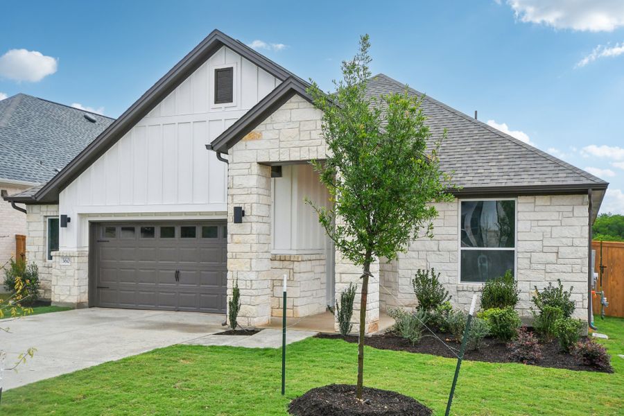 Front exterior of a new home in Persimmon, Buda, TX, highlighting curb appeal (Image 1). Front exterior of a new home in Persimmon, Buda, TX, highlighting curb appeal (Image 1).