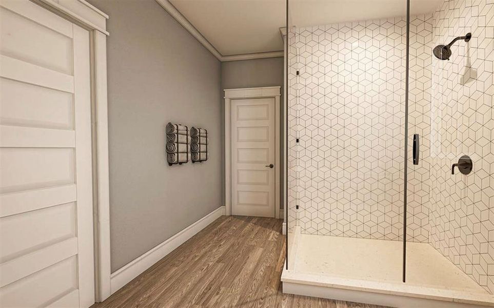 ensuite bathroom with double sinks for convenience, a spacious walk-in shower with tiled finishes, and a generously sized closet designed for two people.