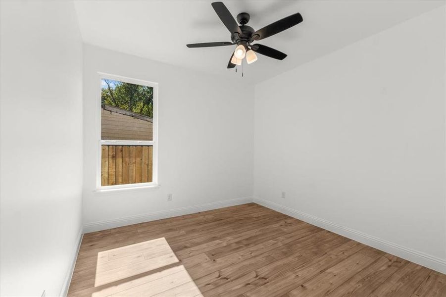 Unfurnished room featuring light wood-style floors and ceiling fan