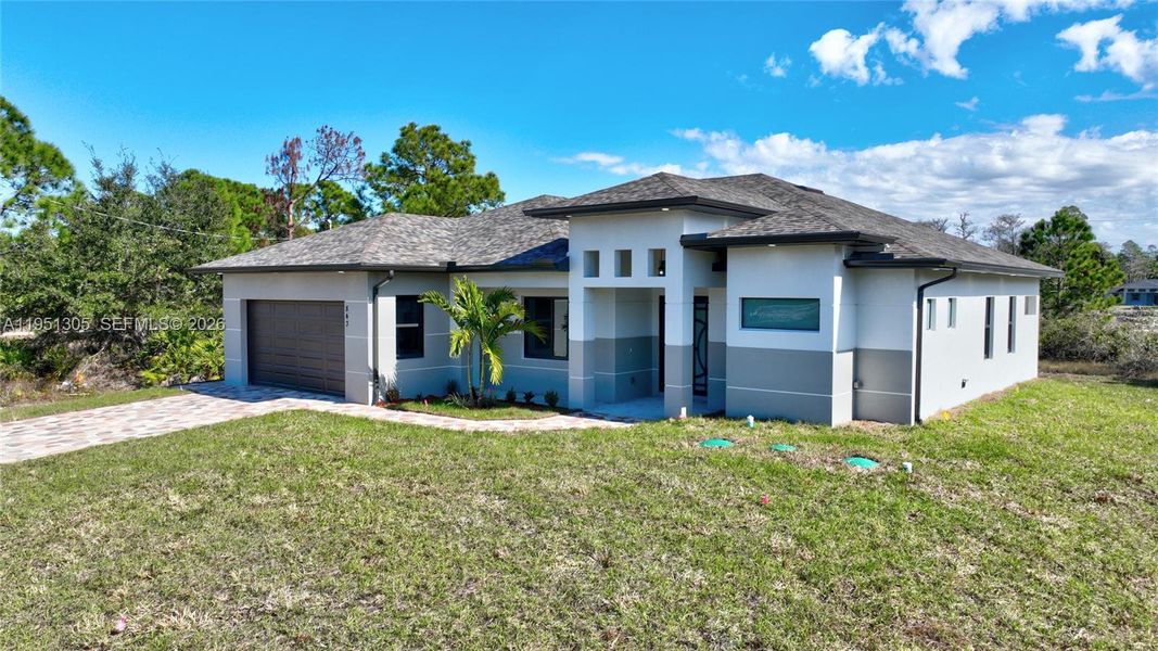 Front exterior of a new home in , Lehigh Acres, FL, highlighting curb appeal (Image 31). Front exterior of a new home in , Lehigh Acres, FL, highlighting curb appeal (Image 31).