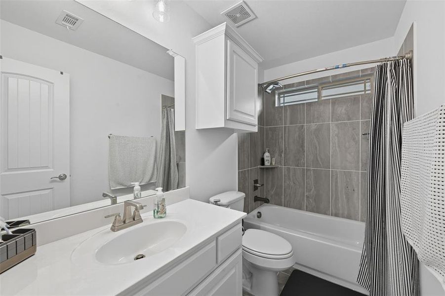 Full bathroom with shower / bath combo with shower curtain and vanity Full bathroom with shower / bath combo with shower curtain and vanity