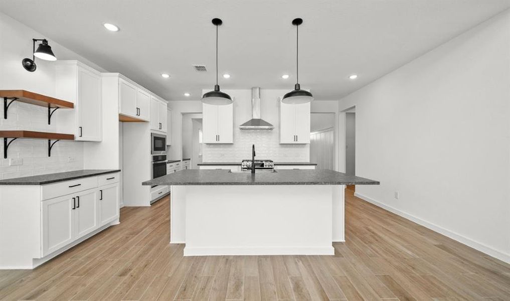 Picture perfect kitchen with a 'farmhouse look' features beautiful maple cabinets, quartz counters, a walk-in pantry & more!