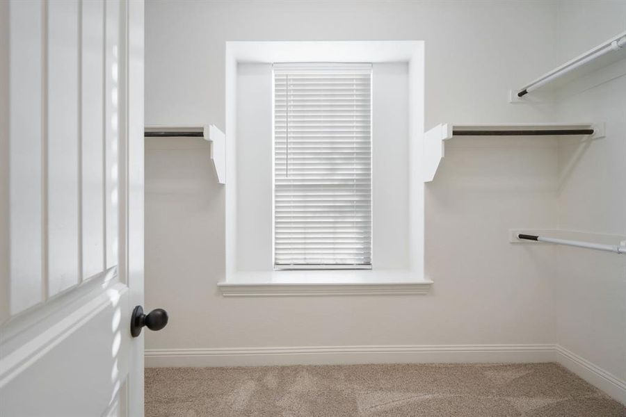 The days of wrestling for closet space are over thanks to this huge walk-in closet.