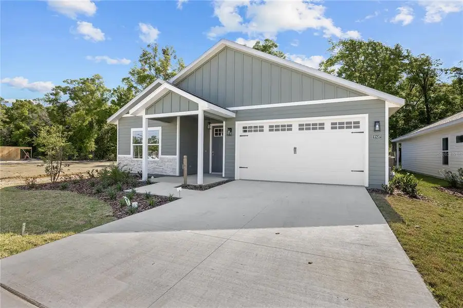 Front exterior of a new home in Grand Oaks, Gainesville, FL, highlighting curb appeal (Image 20).