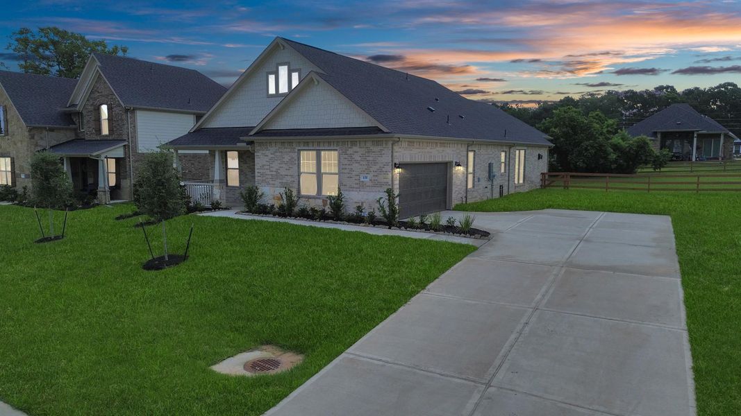 Front exterior of a new home in Timber Hollow: Heritage Collection, Magnolia, TX, highlighting curb appeal (Image 22). Front exterior of a new home in Timber Hollow: Heritage Collection, Magnolia, TX, highlighting curb appeal (Image 22).