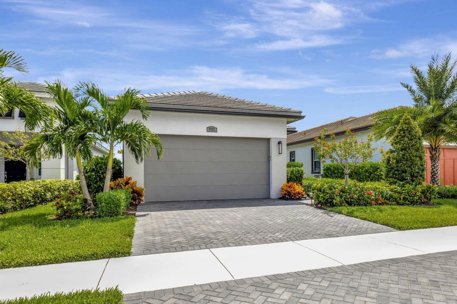 Front exterior of a new home in , Port St. Lucie, FL, highlighting curb appeal (Image 1).