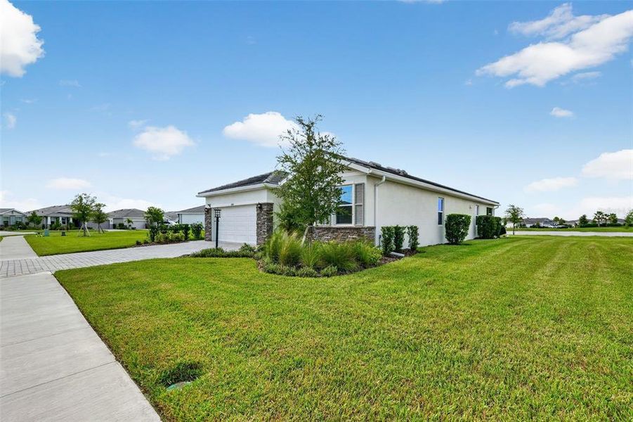 Front exterior of a new home in Star Farms at Lakewood Ranch, Bradenton, FL, highlighting curb appeal (Image 23). Front exterior of a new home in Star Farms at Lakewood Ranch, Bradenton, FL, highlighting curb appeal (Image 23).
