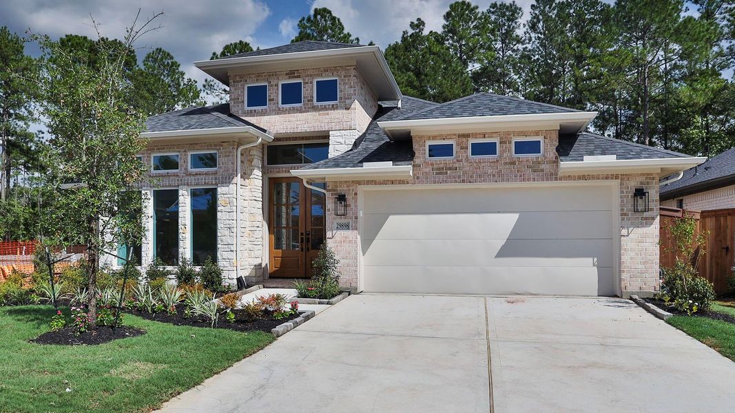Front exterior of a new home in Woodhavyn, Magnolia, TX, highlighting curb appeal (Image 2).