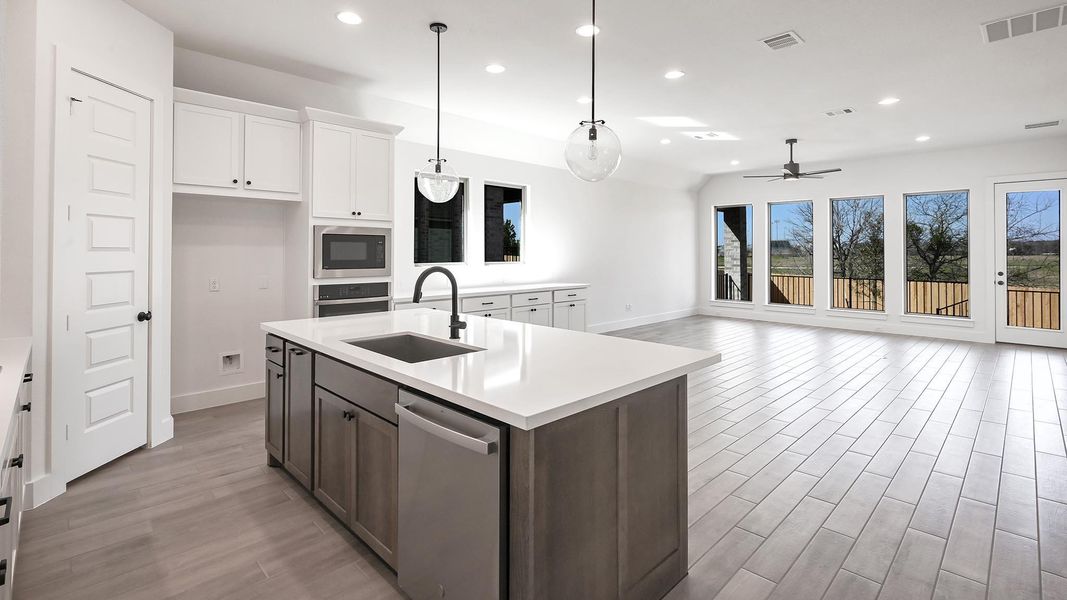 Kitchen featuring stainless steel appliances, a sink, visible vents, and a healthy amount of sunlight