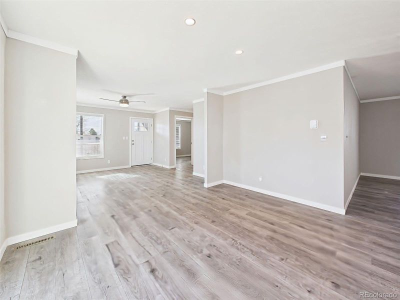 Unstaged Dining Area – Natural light pours into this flexible dining area, with direct access to the backyard deck through large sliding doors.