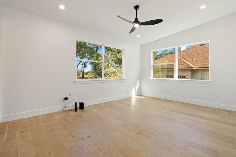 Empty room with light wood-style flooring, recessed lighting, and a ceiling fan