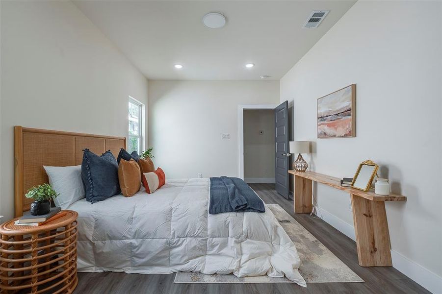 Bedroom with dark hardwood / wood-style flooring