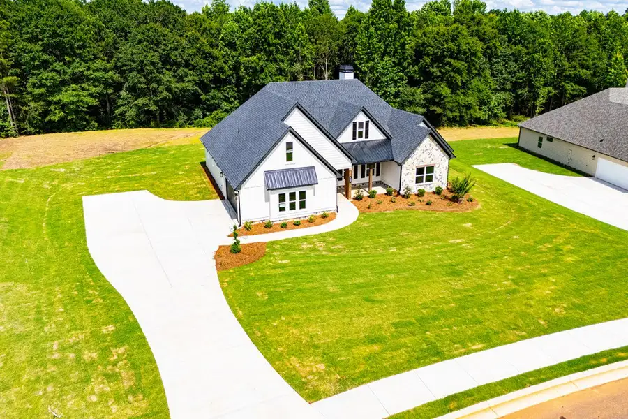 Front exterior of a new home in WOODMONT RESERVE, Roopville, GA, highlighting curb appeal (Image 41).
