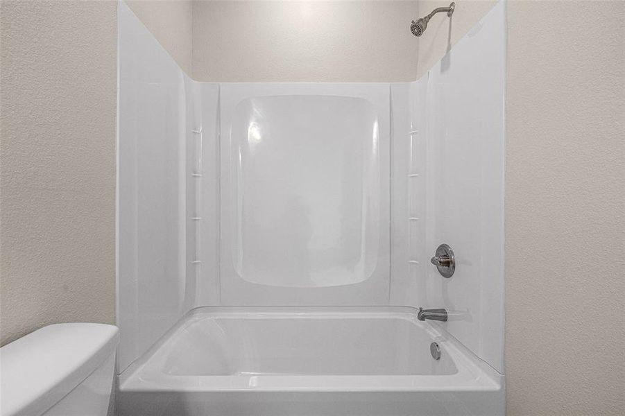 Bathroom with shower / bath combination and toilet