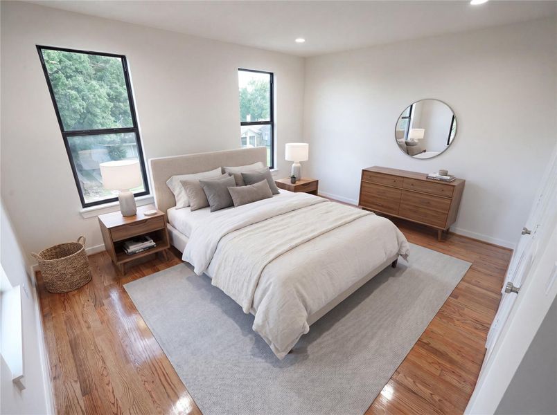 Spacious and filled with natural light, this generously sized guest bedroom features real hardwood floors, oversized windows, and plenty of room for a king-size bed and additional furnishings—offering comfort for family or overnight guests.