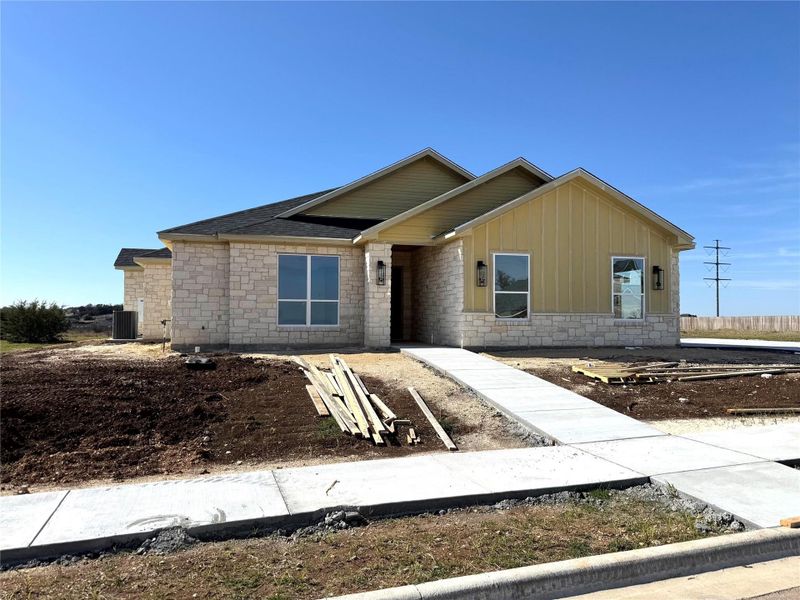 View of front of property with stone siding and board and batten siding