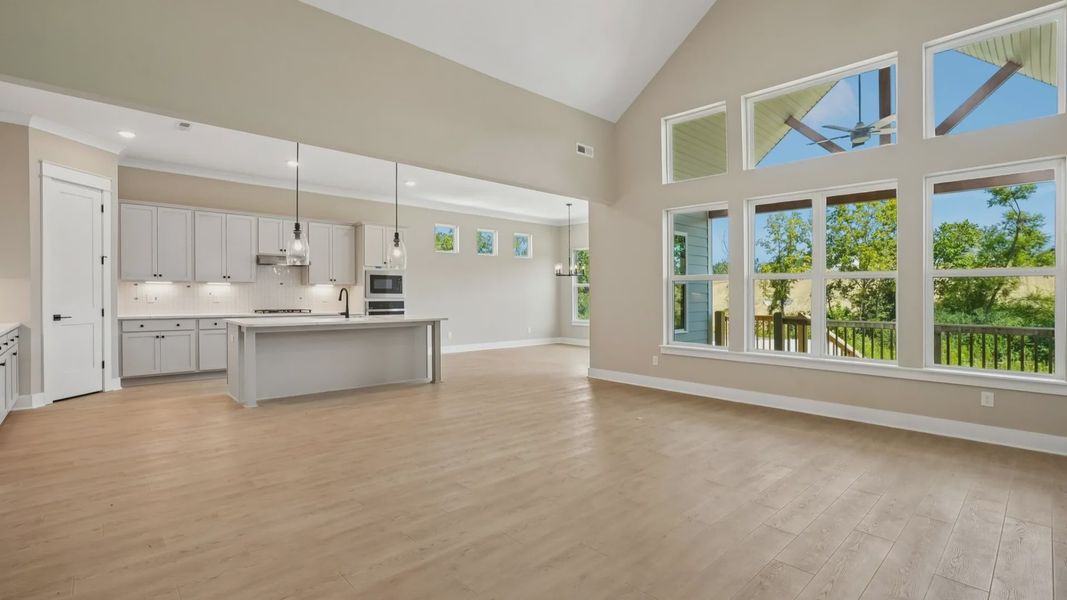 Living area next to kitchen and dining spaces