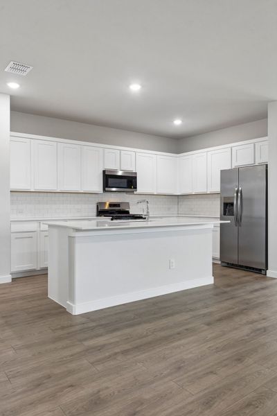 Kitchen in the Oscar home plan by Trophy Signature Homes – REPRESENTATIVE PHOTO