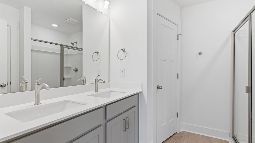 Highly functional and elegant en-suite with dual vanities, tiled walk-in shower, and refined finishes at Silo Ridge