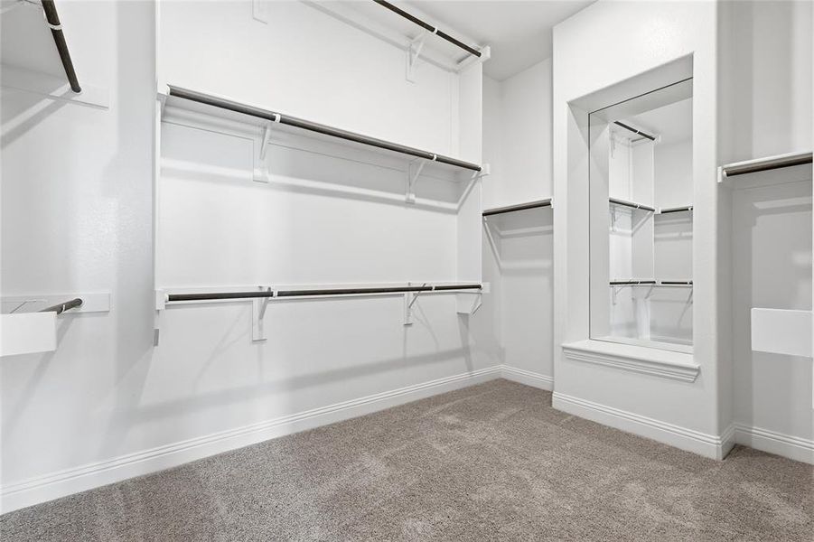 Walk in closet featuring carpet flooring Walk in closet featuring carpet flooring