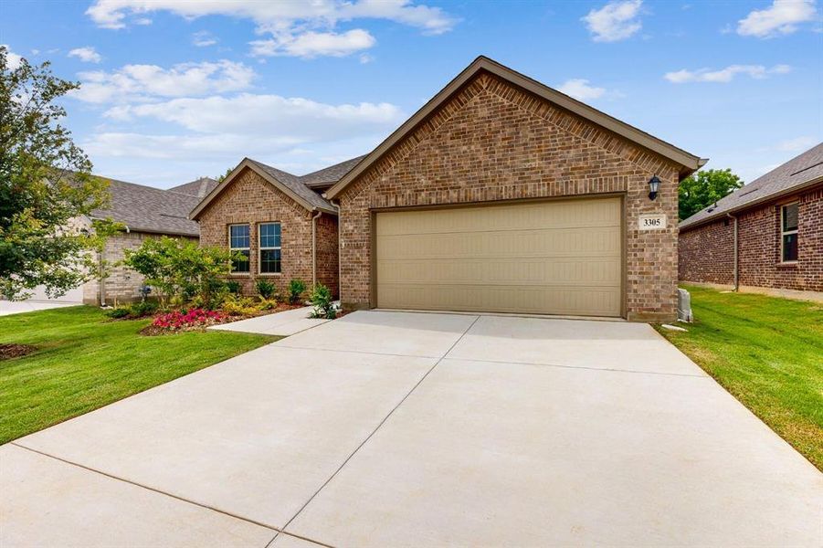 Front exterior of a new home in Kings Way, Denton, TX, highlighting curb appeal (Image 2). Front exterior of a new home in Kings Way, Denton, TX, highlighting curb appeal (Image 2).