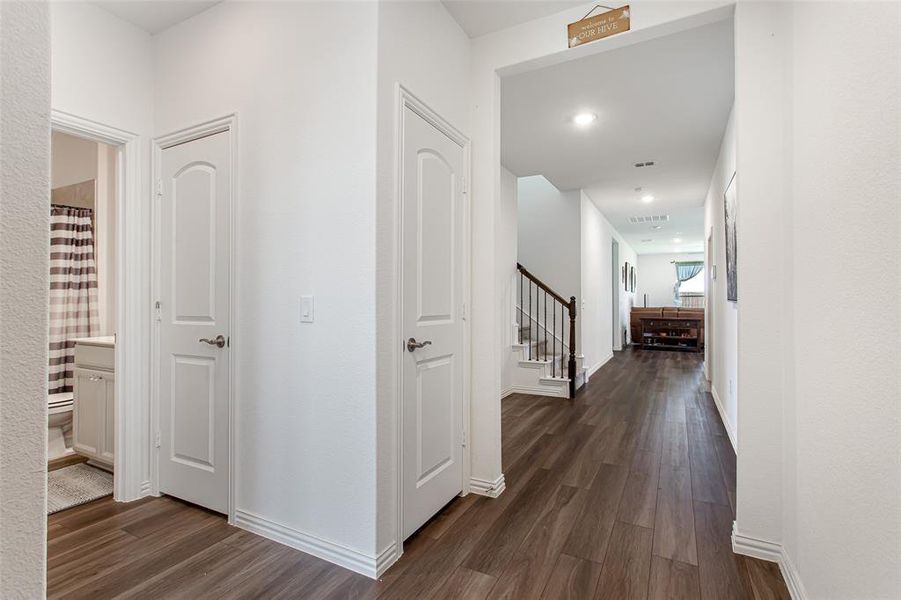 Hall featuring dark wood-style floors and stairway