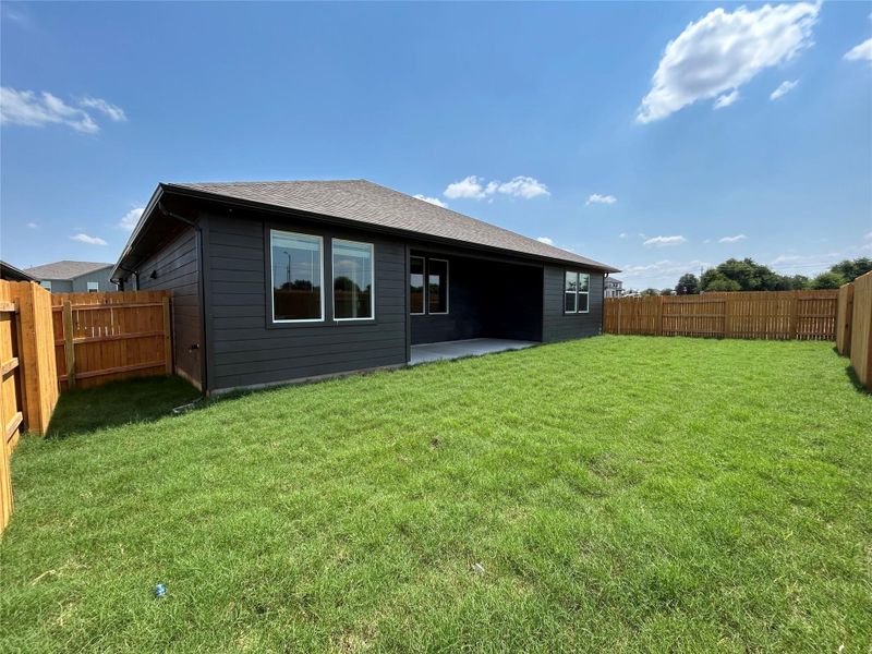 Back of property with a patio, a fenced backyard, and roof with shingles Back of property with a patio, a fenced backyard, and roof with shingles