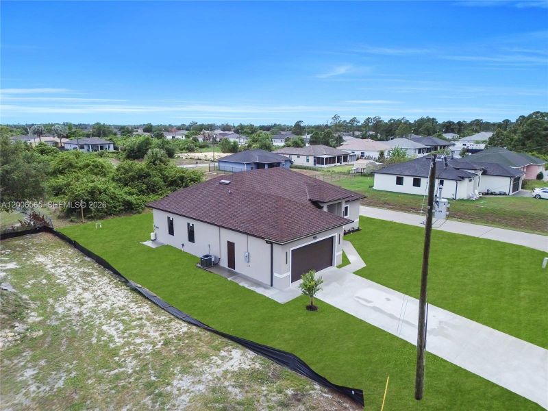 Front exterior of a new home in , Lehigh Acres, FL, highlighting curb appeal (Image 21).
