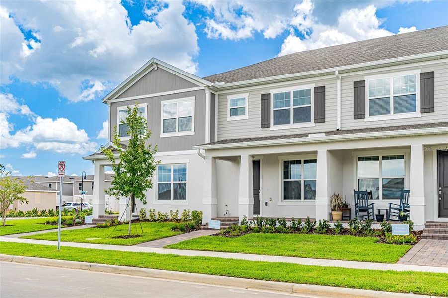 Front exterior of a new home in Osprey Ranch Townhomes, Winter Garden, FL, highlighting curb appeal (Image 18).