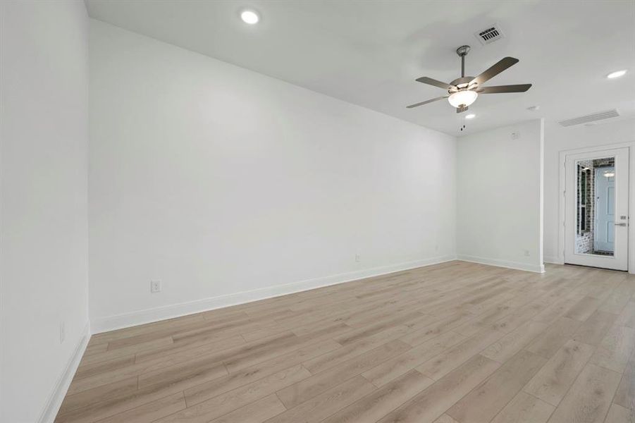Unfurnished room with recessed lighting, light wood-type flooring, and ceiling fan Unfurnished room with recessed lighting, light wood-type flooring, and ceiling fan