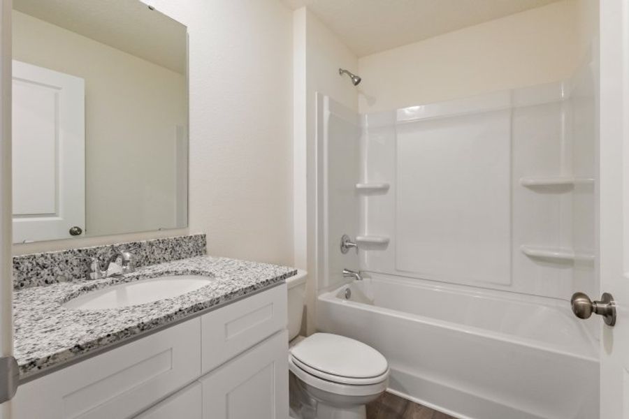 A bathroom with a sink and a toilet.