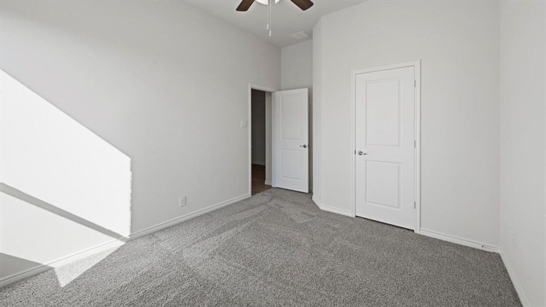 Unfurnished bedroom featuring carpet flooring and a ceiling fan