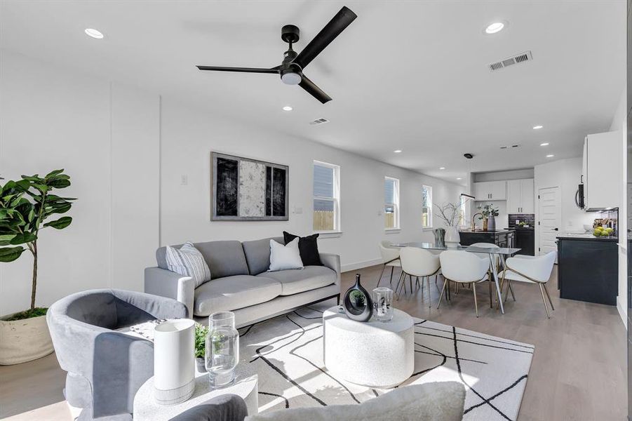 Living room featuring light hardwood / wood-style flooring and ceiling fan