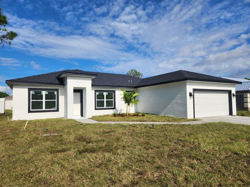 Front exterior of a new home in , Palm Bay, FL, highlighting curb appeal (Image 2). Front exterior of a new home in , Palm Bay, FL, highlighting curb appeal (Image 2).