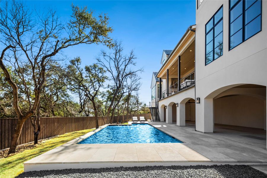 View of pool featuring a patio, stairs, and a fenced backyard View of pool featuring a patio, stairs, and a fenced backyard