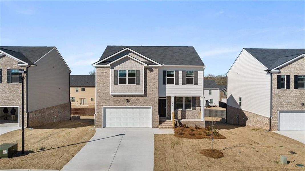 Front exterior of a new home in The Reserve at Calcutta, Stockbridge, GA, highlighting curb appeal (Image 16). Front exterior of a new home in The Reserve at Calcutta, Stockbridge, GA, highlighting curb appeal (Image 16).