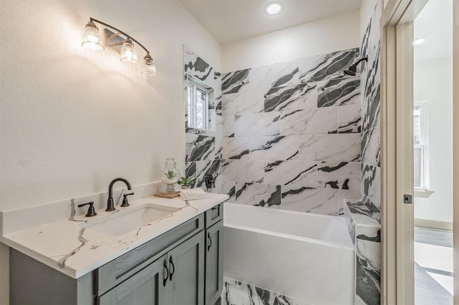 Bathroom featuring vanity and bathing tub / shower combination