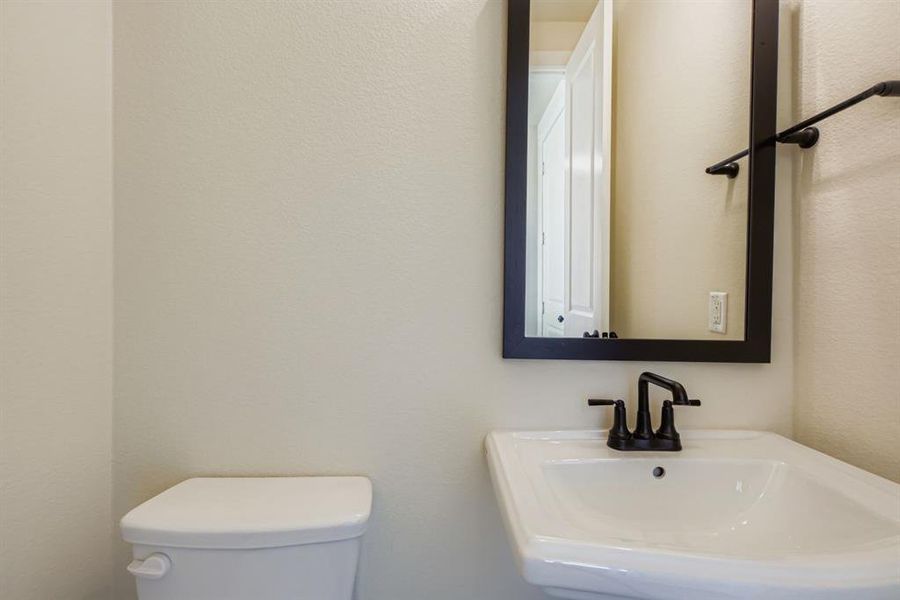 Bathroom featuring a sink and a textured wall