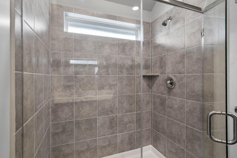 A spacious, contemporary walk-in shower featuring elegant, tile surround, a built-in shampoo niche, and a sleek glass enclosure. A spacious, contemporary walk-in shower featuring elegant, tile surround, a built-in shampoo niche, and a sleek glass enclosure.