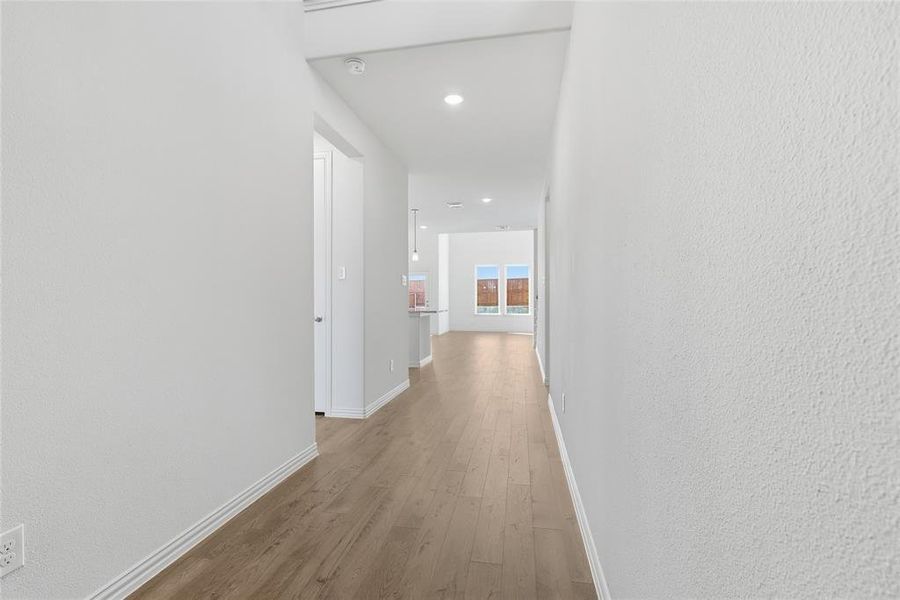 Hallway featuring light wood-style floors and recessed lighting
