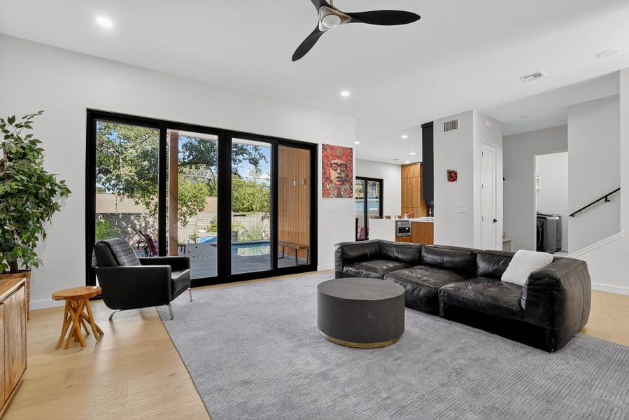 Living area with light wood-type flooring, recessed lighting, plenty of natural light, and ceiling fan