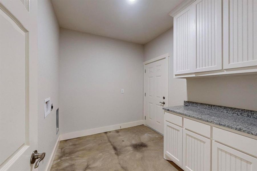 Washroom with cabinets and hookup for a washing machine