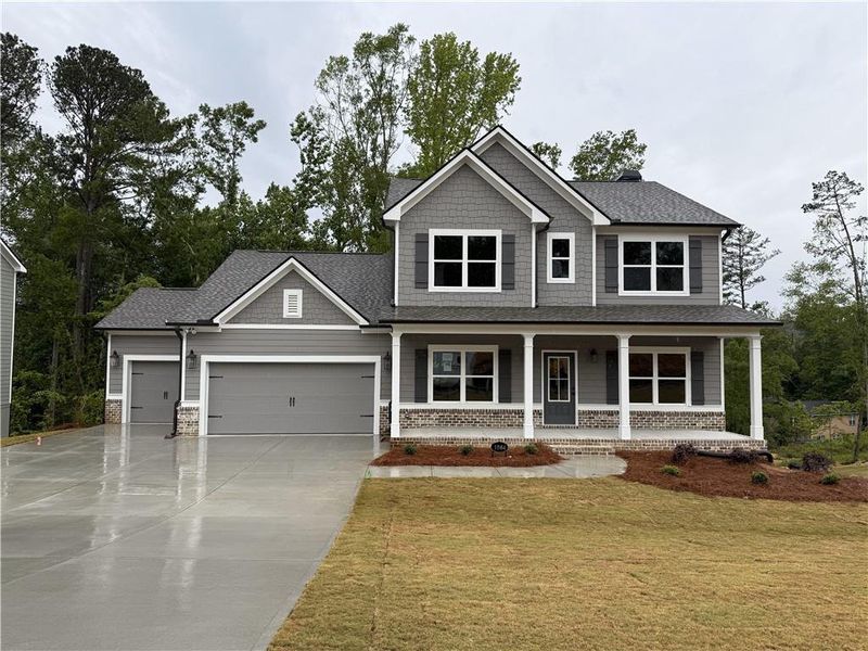 Front exterior of a new home in Woodland Hills, Loganville, GA, highlighting curb appeal (Image 1). Front exterior of a new home in Woodland Hills, Loganville, GA, highlighting curb appeal (Image 1).