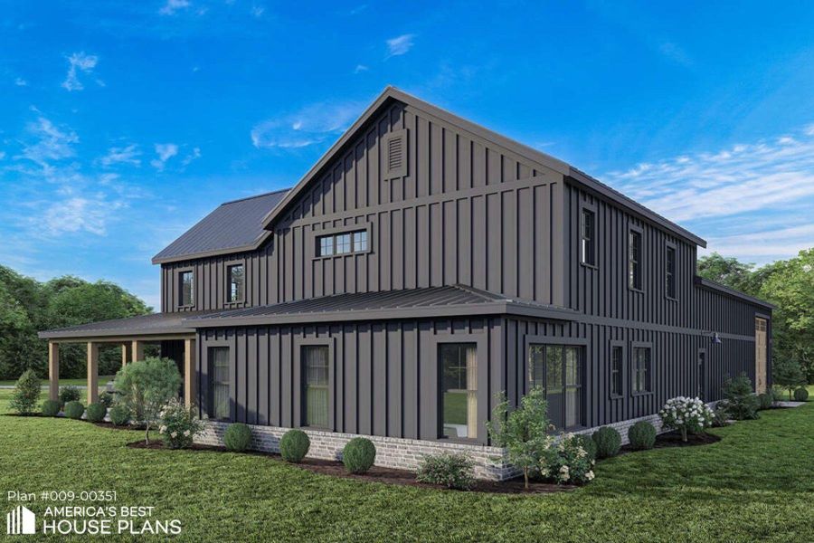 View of side of home with board and batten siding, a yard, and a metal roof