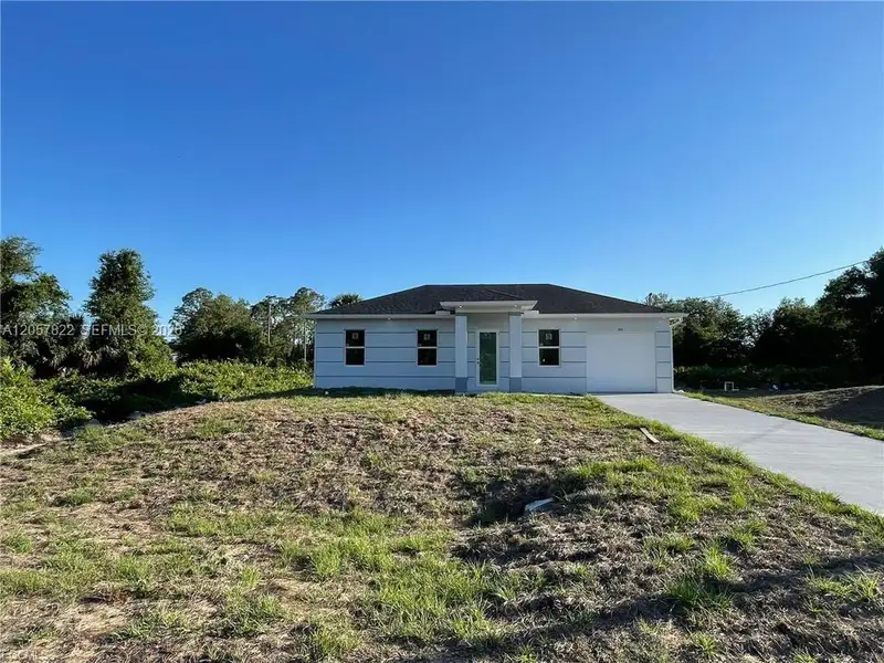 Front exterior of a new home in , Lehigh Acres, FL, highlighting curb appeal (Image 2). Front exterior of a new home in , Lehigh Acres, FL, highlighting curb appeal (Image 2).
