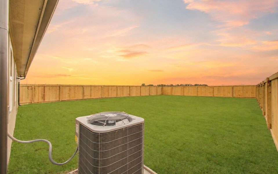 A wide-open backyard framed by new privacy fencing and beautiful sunset views. (Sky Virtually Enhanced)