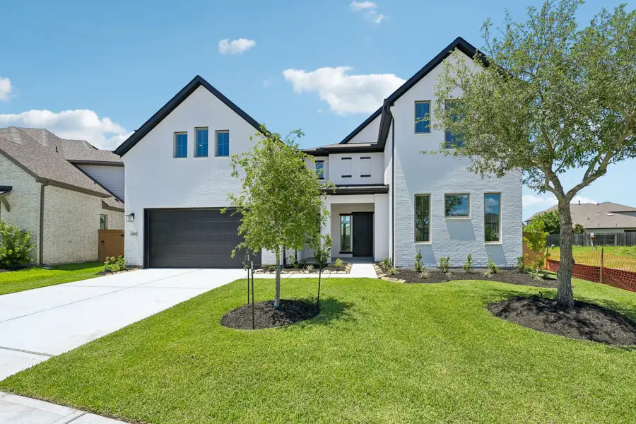 Front exterior of a new home in Marvida, Cypress, TX, highlighting curb appeal (Image 1). Front exterior of a new home in Marvida, Cypress, TX, highlighting curb appeal (Image 1).